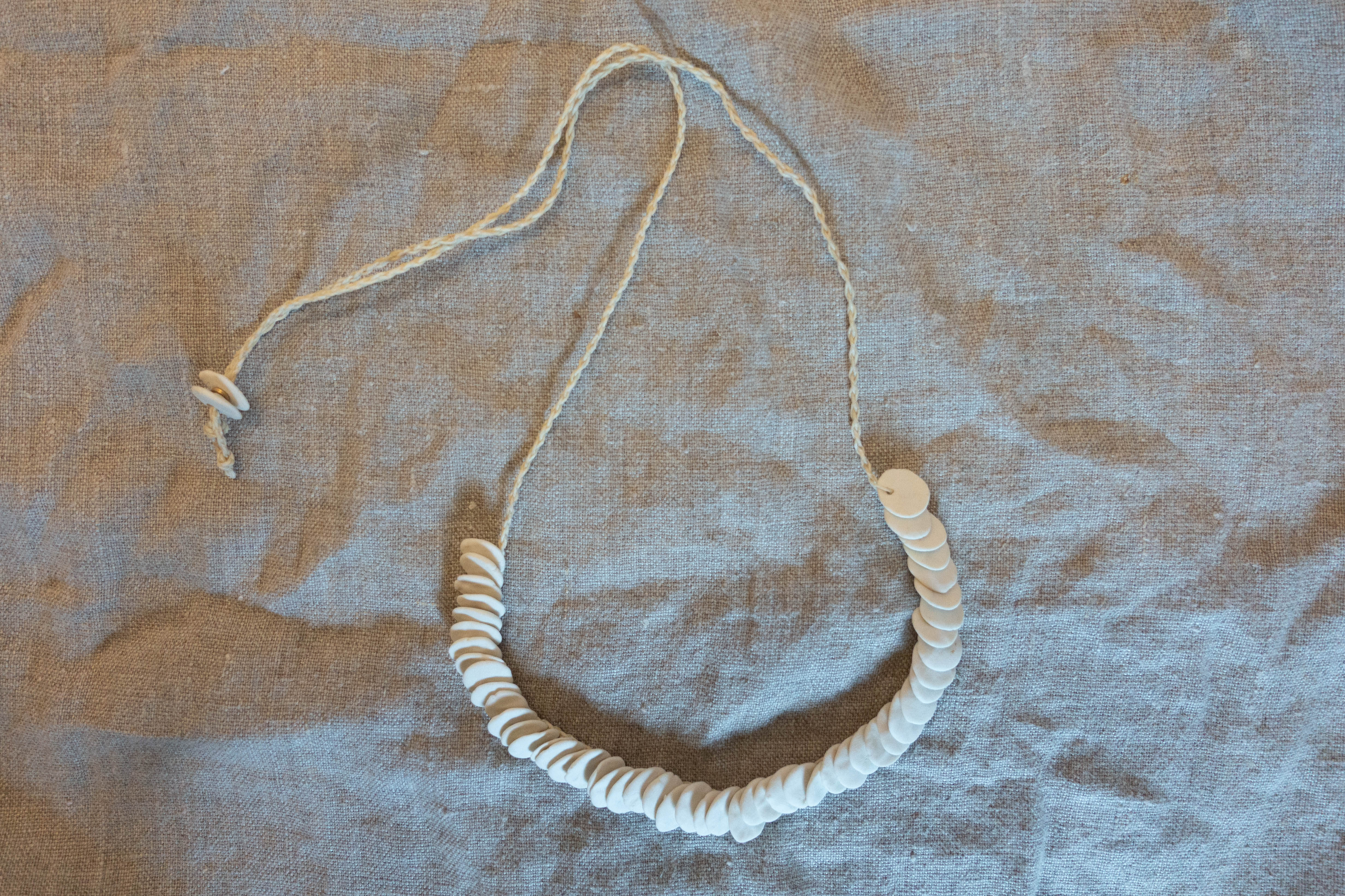 Woven necklace disc