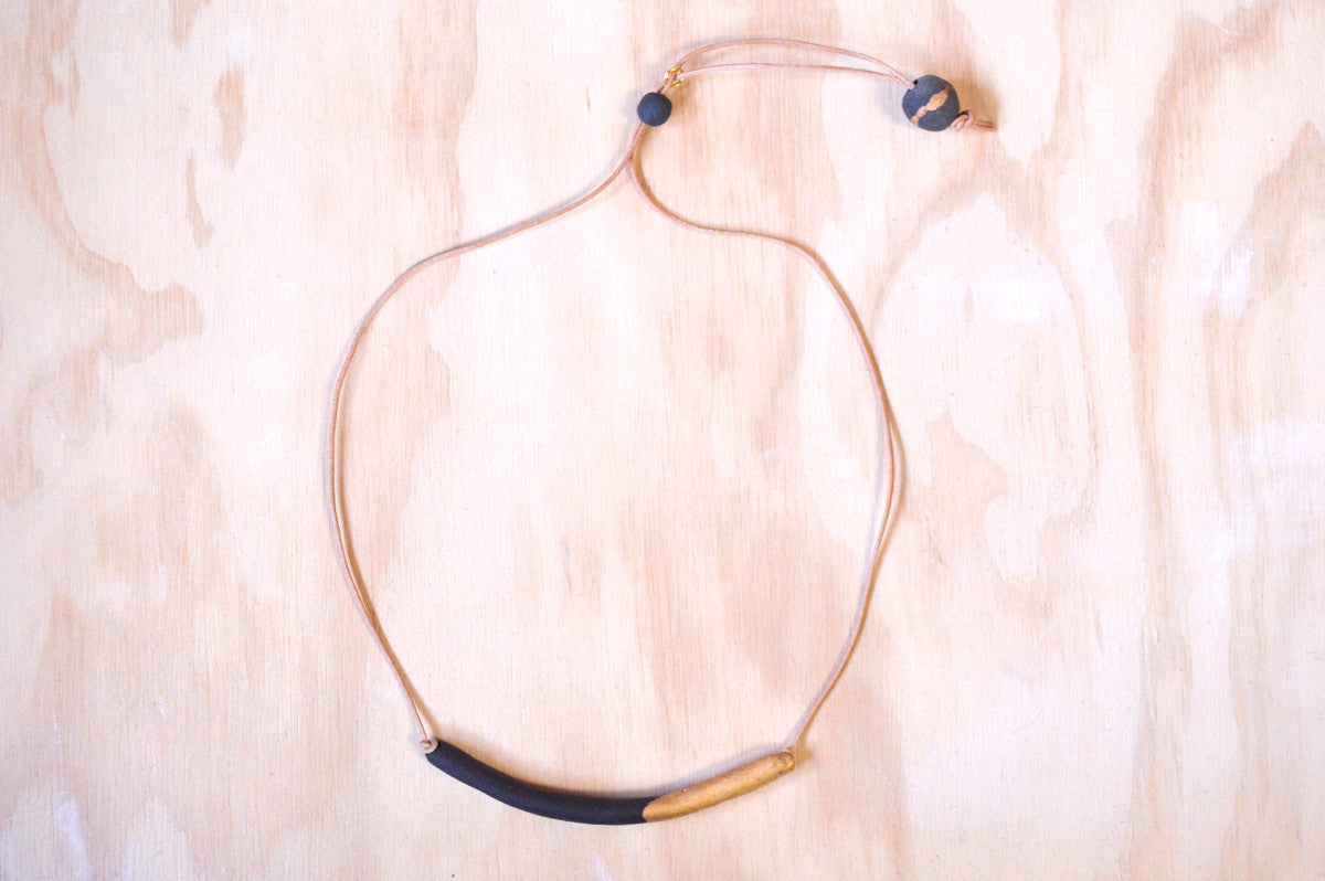 Necklace black tube, gold dipped